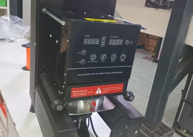 Automatic cup sealer