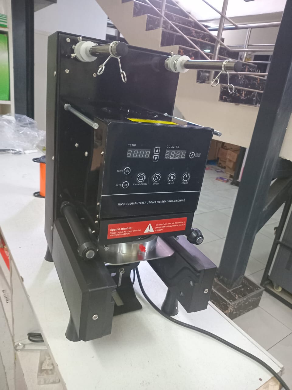 Automatic cup sealer